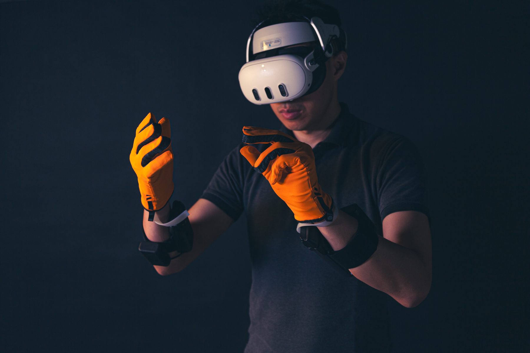 Someone in a Quest 3 headset reaching out with both hands in HexR gloves